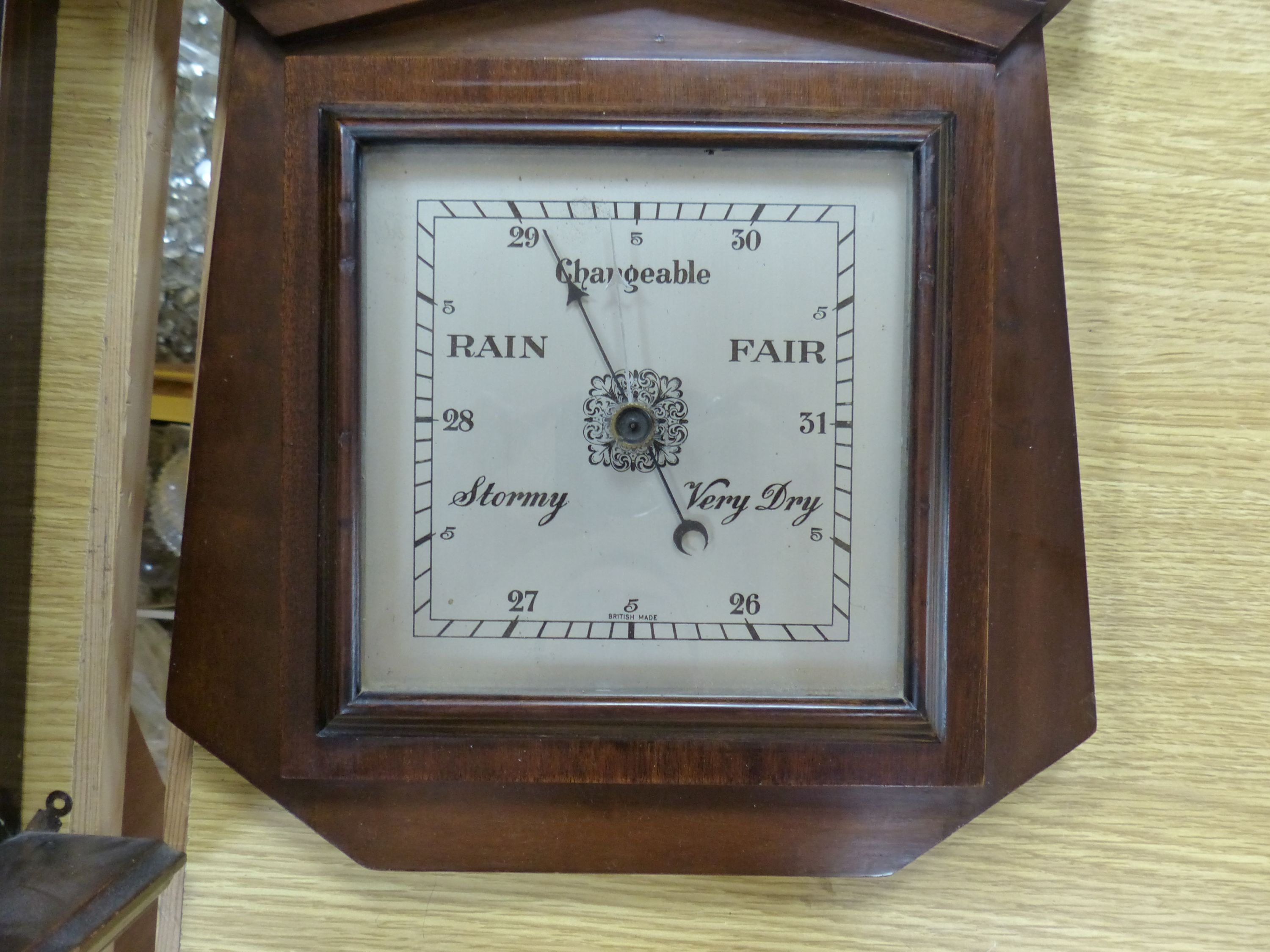 A 19th century German walnut wall clock with pendulum and key, height 58cm, and a mahogany barometer